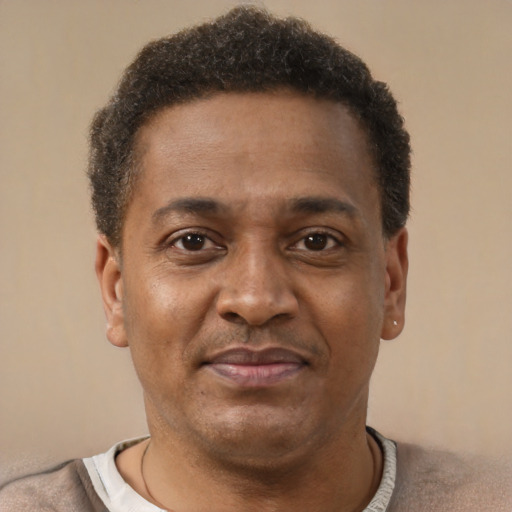 Joyful latino adult male with short  brown hair and brown eyes