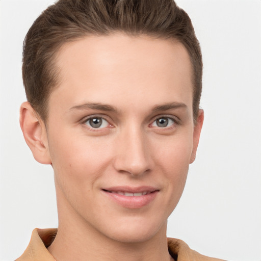 Joyful white young-adult female with short  brown hair and grey eyes