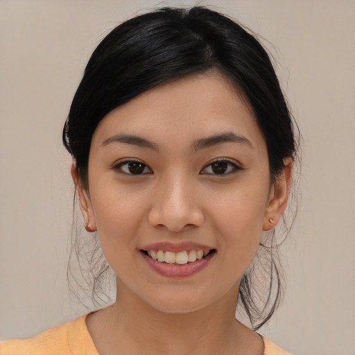 Joyful asian young-adult female with medium  black hair and brown eyes