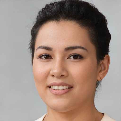 Joyful latino young-adult female with medium  brown hair and brown eyes