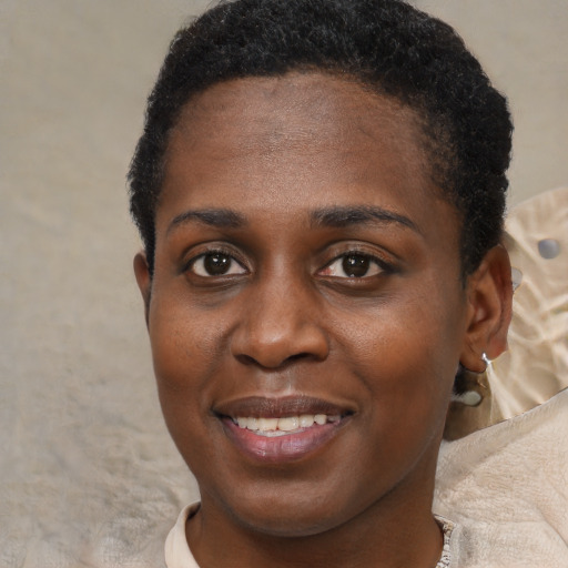 Joyful black young-adult female with short  brown hair and brown eyes