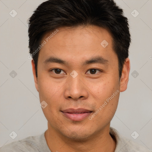 Joyful asian young-adult male with short  brown hair and brown eyes