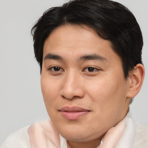 Joyful asian young-adult male with short  brown hair and brown eyes