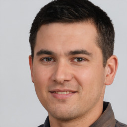 Joyful white young-adult male with short  brown hair and brown eyes