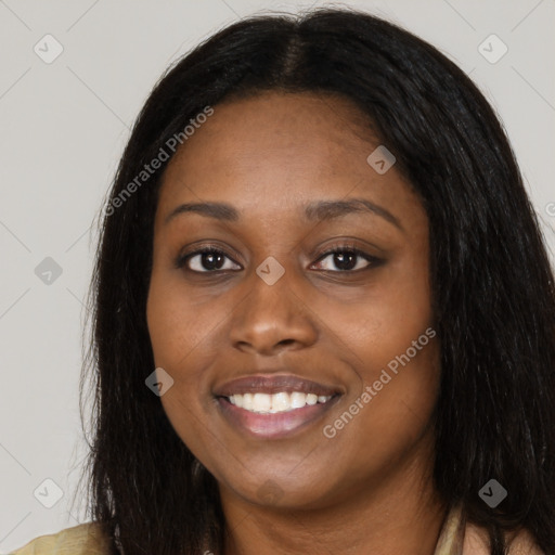 Joyful black young-adult female with long  black hair and brown eyes