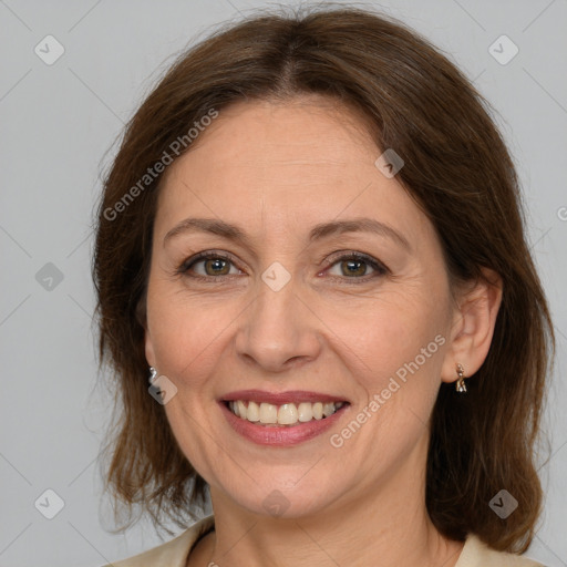 Joyful white adult female with medium  brown hair and grey eyes