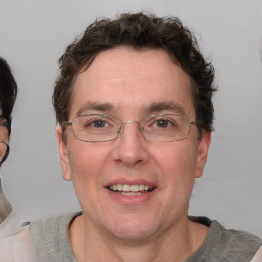 Joyful white adult male with short  brown hair and blue eyes