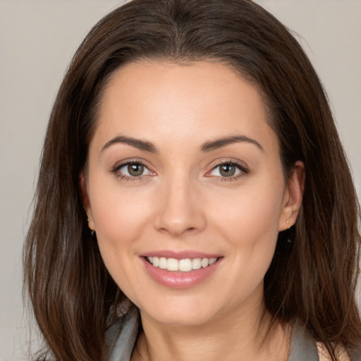 Joyful white young-adult female with medium  brown hair and brown eyes