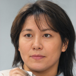 Joyful asian adult female with medium  brown hair and brown eyes