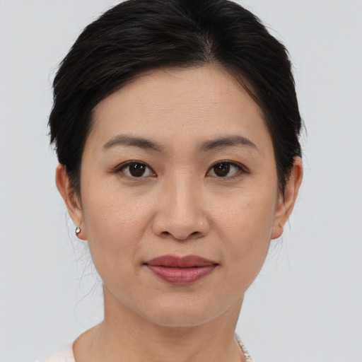 Joyful asian young-adult female with medium  brown hair and brown eyes
