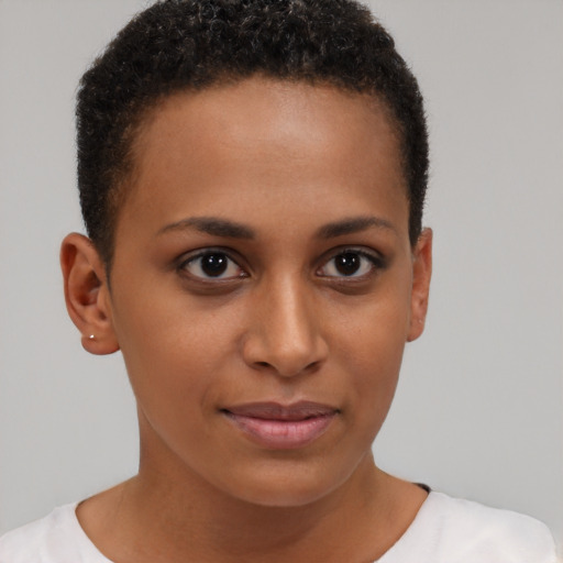 Joyful black young-adult female with short  brown hair and brown eyes