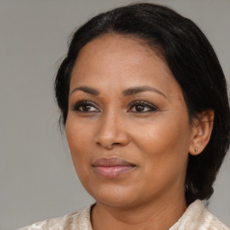 Joyful black adult female with medium  brown hair and brown eyes