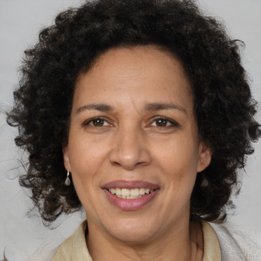 Joyful black adult female with medium  brown hair and brown eyes