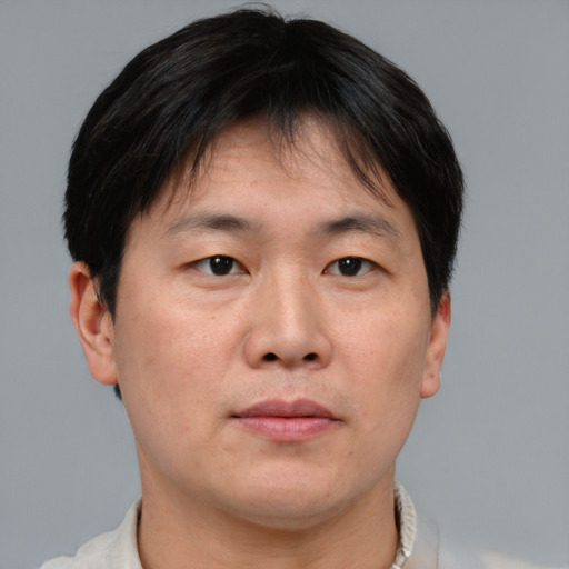 Neutral asian adult male with short  brown hair and brown eyes