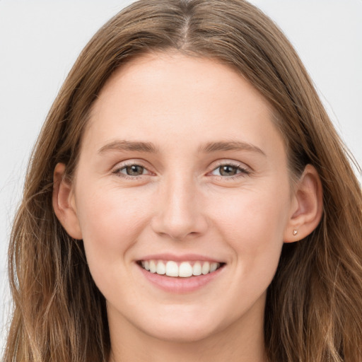 Joyful white young-adult female with long  brown hair and grey eyes