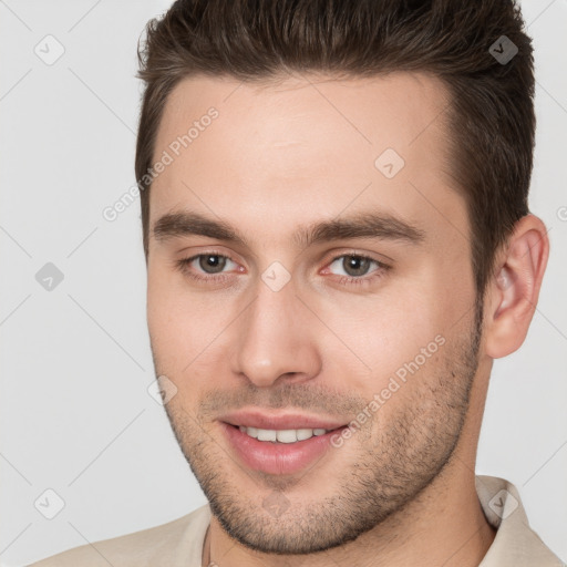 Joyful white young-adult male with short  brown hair and brown eyes