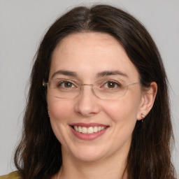 Joyful white adult female with long  brown hair and brown eyes