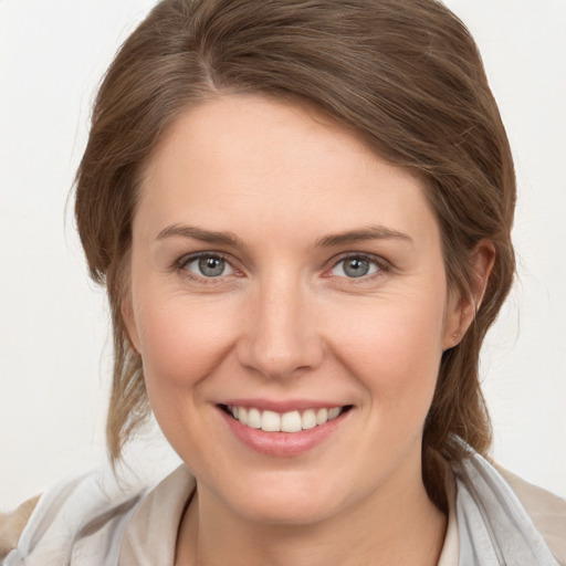 Joyful white young-adult female with medium  brown hair and grey eyes