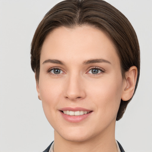 Joyful white young-adult female with short  brown hair and grey eyes