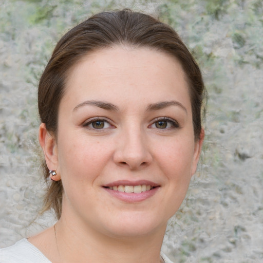 Joyful white young-adult female with medium  brown hair and grey eyes