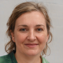 Joyful white adult female with medium  brown hair and grey eyes