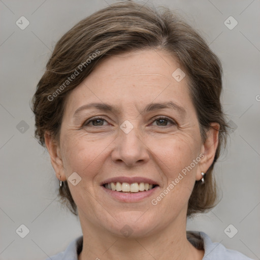 Joyful white adult female with medium  brown hair and grey eyes