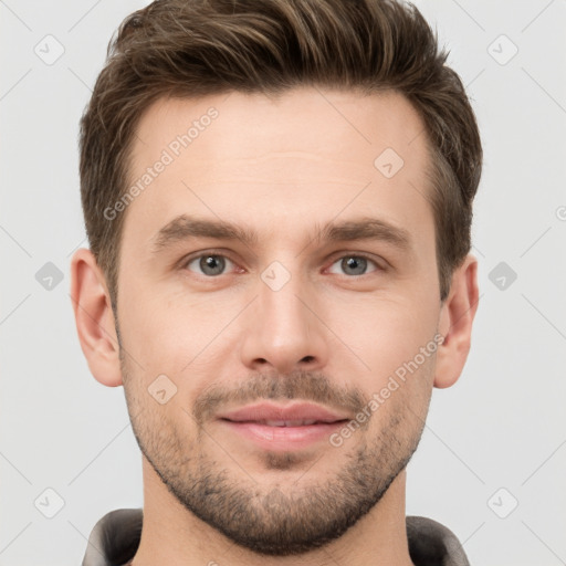 Joyful white young-adult male with short  brown hair and grey eyes