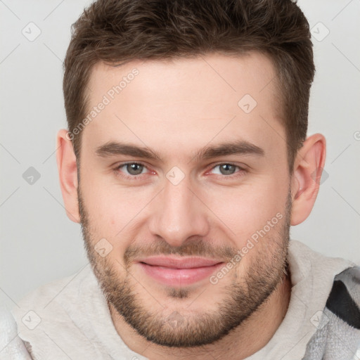 Joyful white young-adult male with short  brown hair and brown eyes