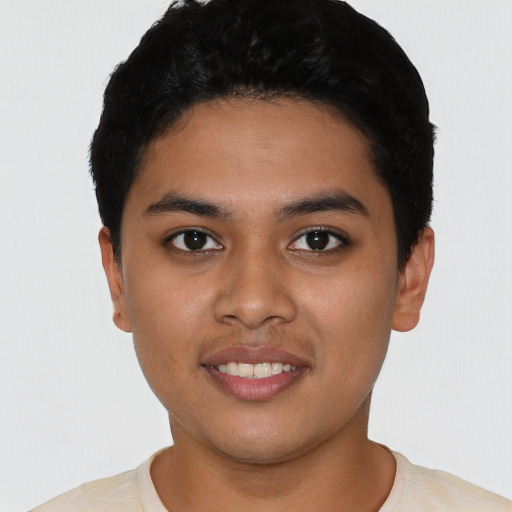 Joyful latino young-adult male with short  black hair and brown eyes