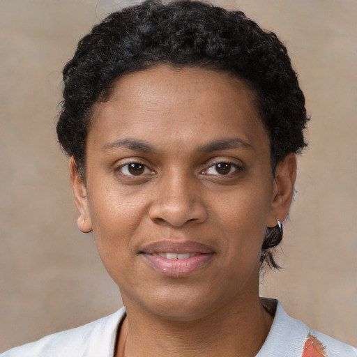 Joyful latino young-adult female with short  black hair and brown eyes