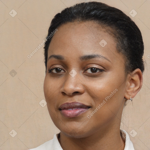 Joyful black young-adult female with short  black hair and brown eyes