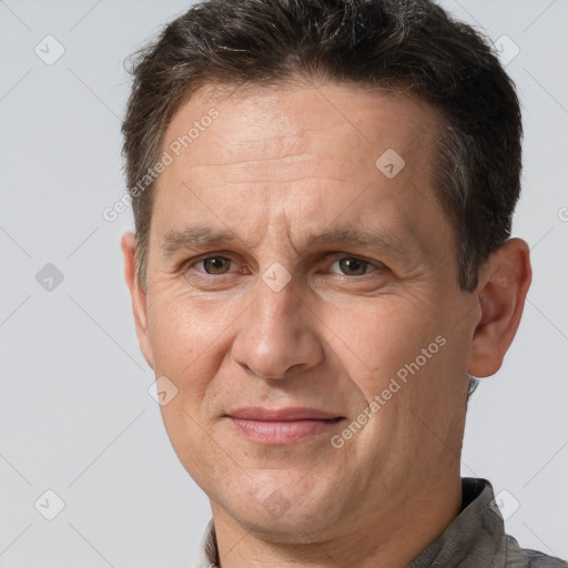 Joyful white adult male with short  brown hair and brown eyes