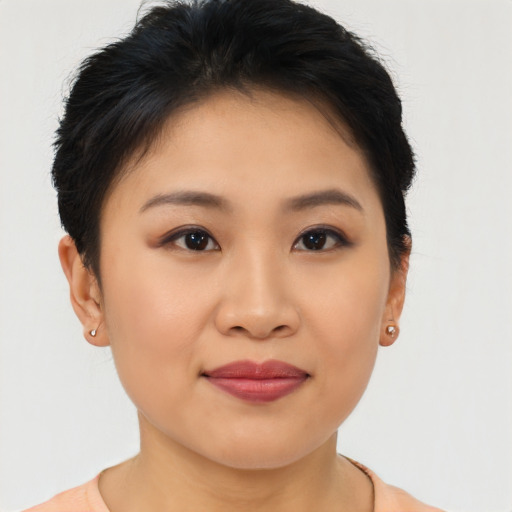 Joyful asian young-adult female with short  brown hair and brown eyes