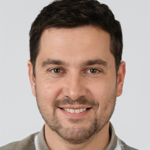 Joyful white adult male with short  brown hair and brown eyes