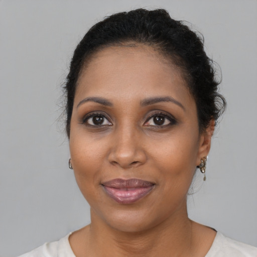 Joyful black young-adult female with medium  brown hair and brown eyes