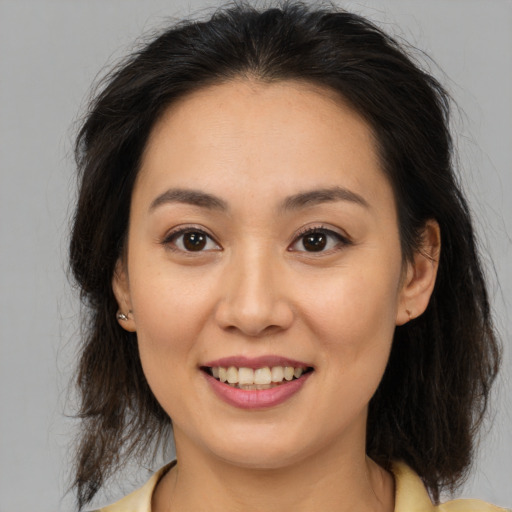 Joyful white young-adult female with medium  brown hair and brown eyes