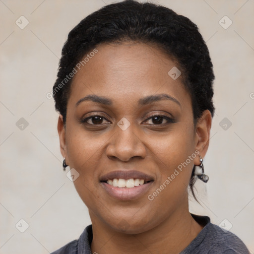 Joyful black young-adult female with short  black hair and brown eyes