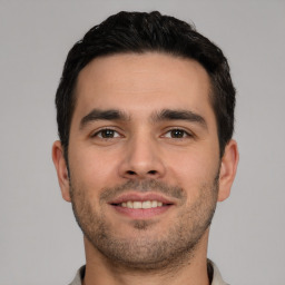 Joyful white young-adult male with short  brown hair and brown eyes