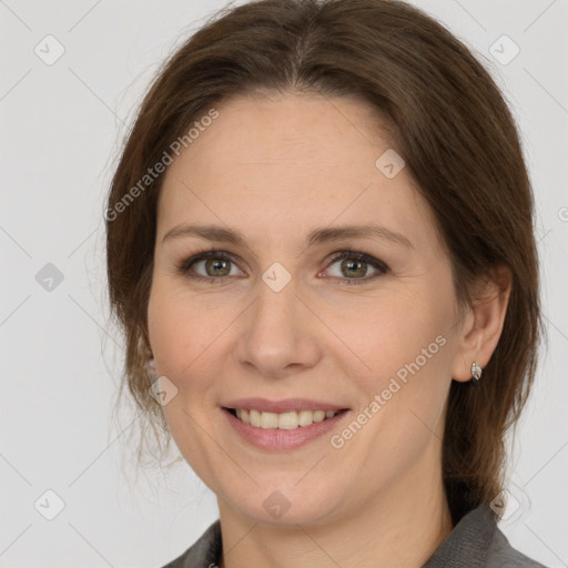 Joyful white adult female with medium  brown hair and grey eyes