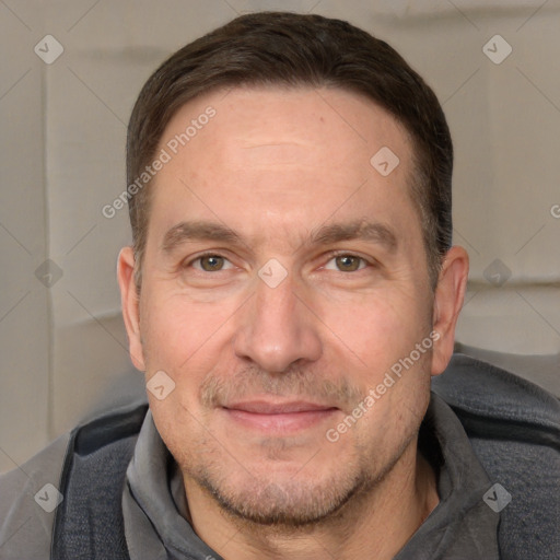 Joyful white adult male with short  brown hair and grey eyes