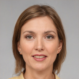 Joyful white adult female with medium  brown hair and grey eyes