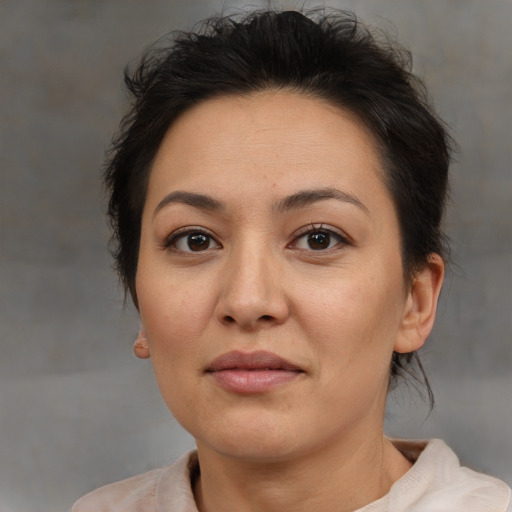 Joyful latino adult female with medium  brown hair and brown eyes