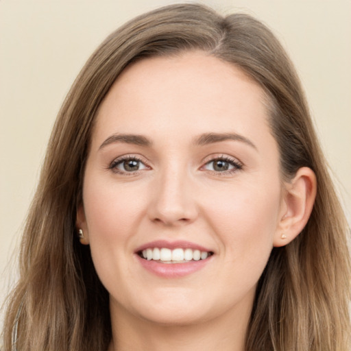 Joyful white young-adult female with long  brown hair and grey eyes