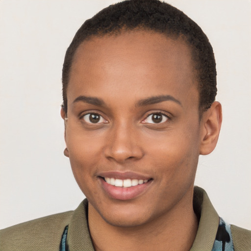 Joyful black young-adult female with short  brown hair and brown eyes