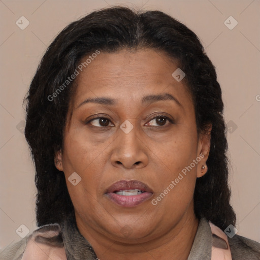 Joyful latino adult female with medium  brown hair and brown eyes