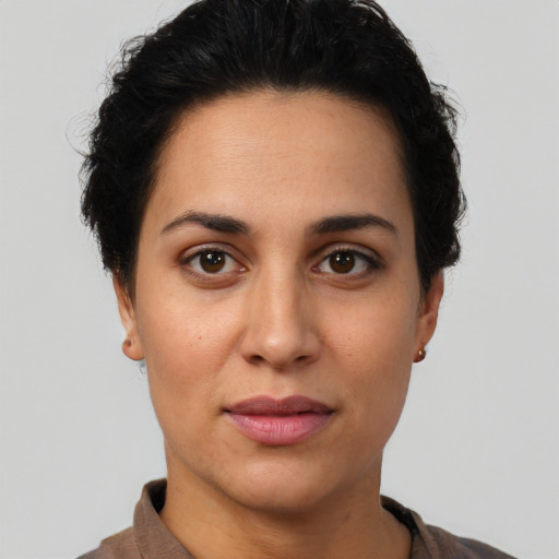 Joyful latino young-adult female with short  brown hair and brown eyes