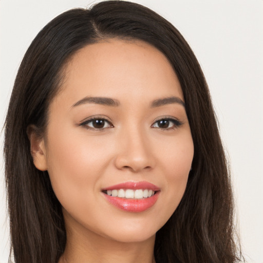 Joyful white young-adult female with long  brown hair and brown eyes