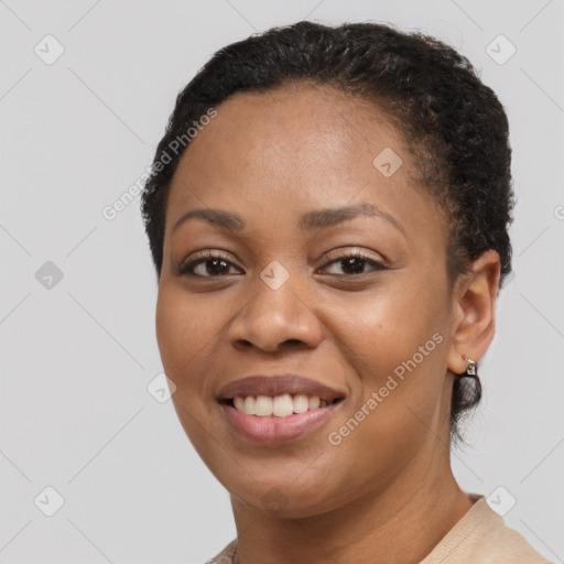 Joyful black young-adult female with short  brown hair and brown eyes