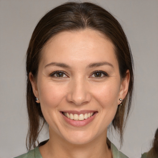Joyful white young-adult female with medium  brown hair and brown eyes