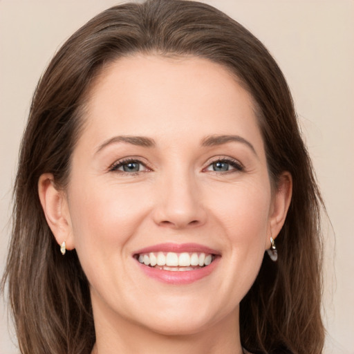 Joyful white young-adult female with medium  brown hair and green eyes